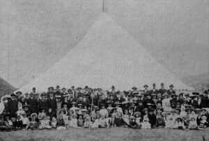 Attendees at the 1906 camp meeting of Seventh-day Adventists, held in Island Bay, Wellington, standing in front of a large tent.