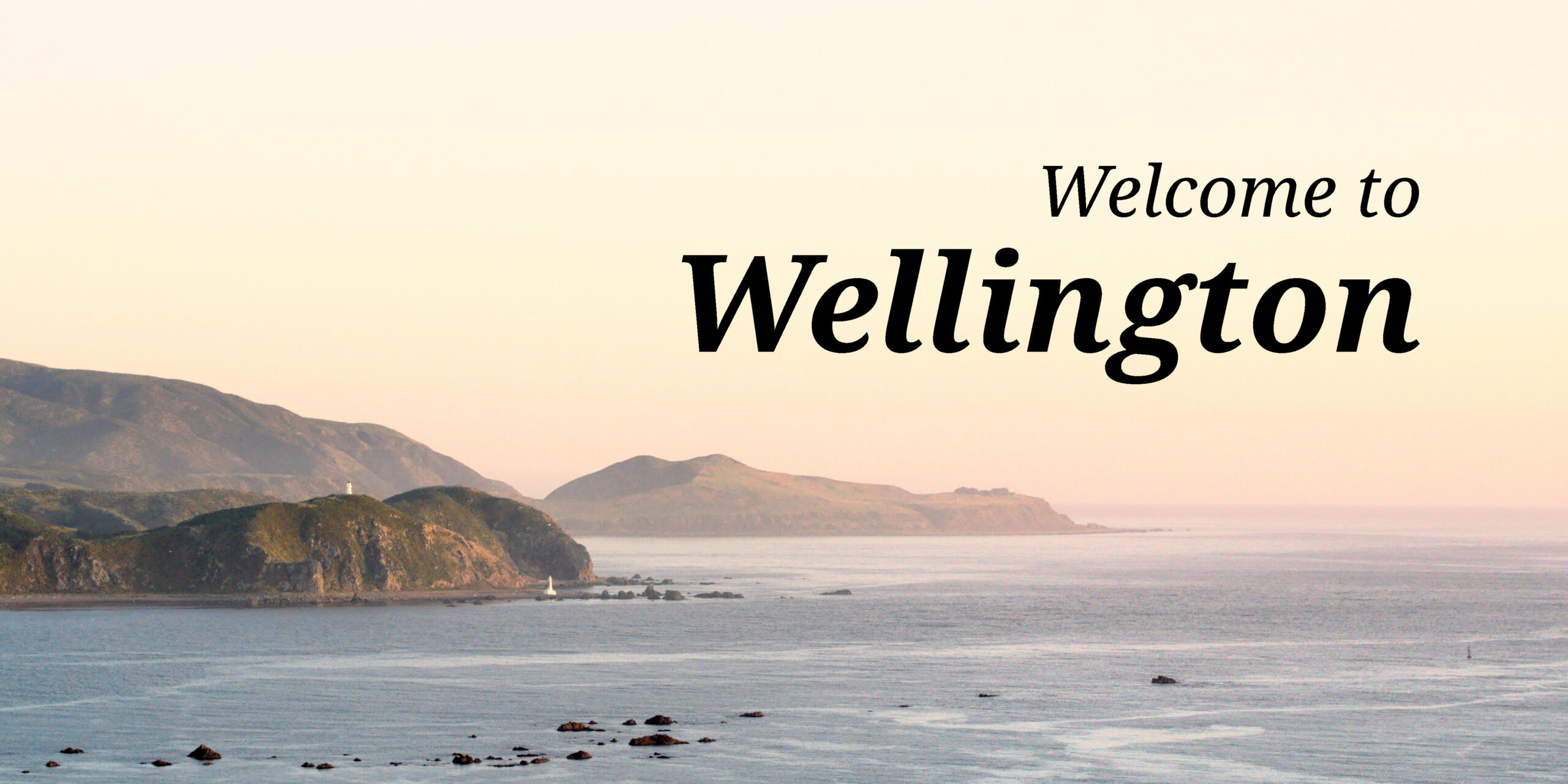 A photo of the entrance to Wellington harbour with the words "Welcome to Wellington"